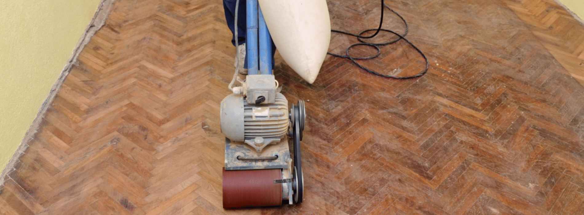 Dedicated team at Mr Sander® in Hendon, NW4, skilfully restoring a herringbone floor using a 2000-effect, 400mm Bona belt sander, set to a voltage of 220 and frequency of 5060, ensuring clean operations with a dust extraction system featuring a HEPA filter.