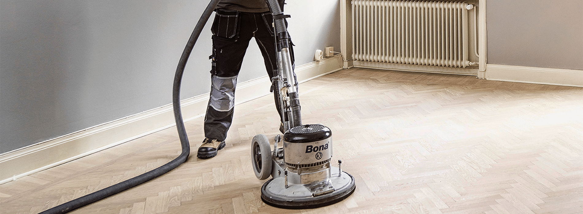 Mr Sander® skillfully sanding a herringbone floor using the powerful Effect 2200 Bona belt sander (250x750 mm) in Stockwell, SW9. With a dust extraction system and HEPA filter, we ensure a clean and efficient result. 