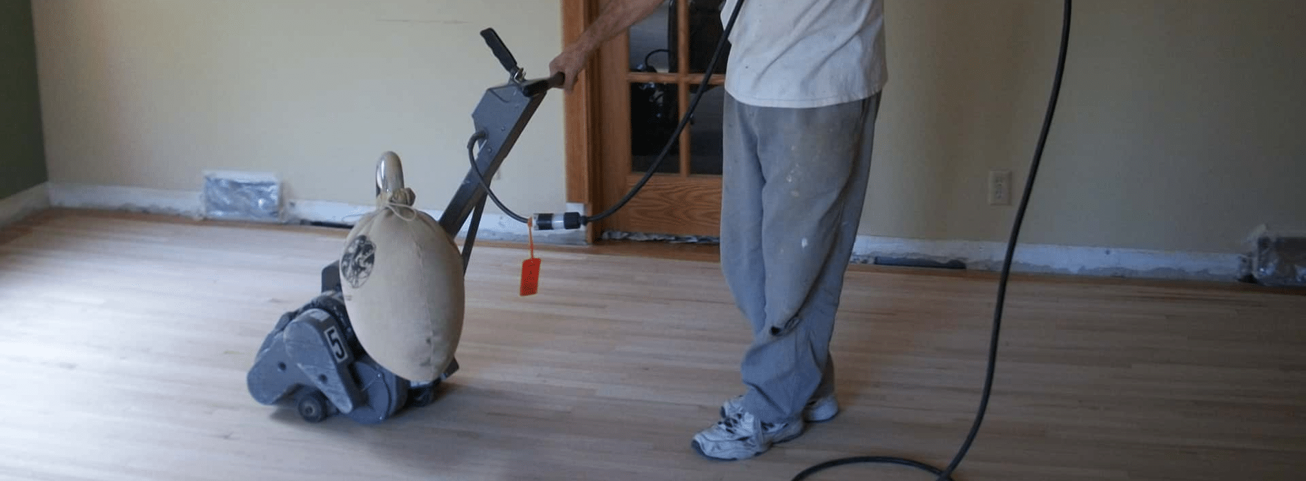 Mr Sander® operating a 2.2 kW, 220V, 60Hz Bona belt sander on a parquet floor in Blackheath, SE3. The image highlights the HEPA-filtered dust extraction system, promising a clean, efficient restoration with remarkable sanding outcomes and minimal dust.
