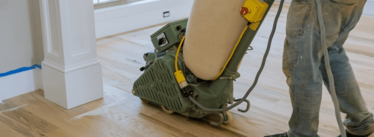 Mr Sander® masterfully sanding a herringbone floor in Crystal Palace, SE19, using a 2.2 kW, 220V, 60Hz, 250x750 mm Bona belt sander. Integrated with a HEPA-filtered dust extraction system for pristine, efficient results.