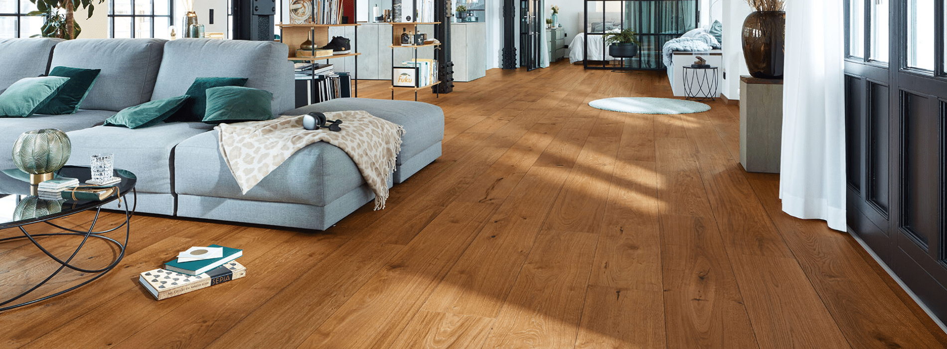 Expertly restored engineered oak floors in Havering Bower, RM4 by Mr Sander®. Marvel at the stunning transformation achieved through meticulous sanding, a mid-oak stain enhancement, and the application of four coats of Junckers Strong satin finish for long-lasting durability.