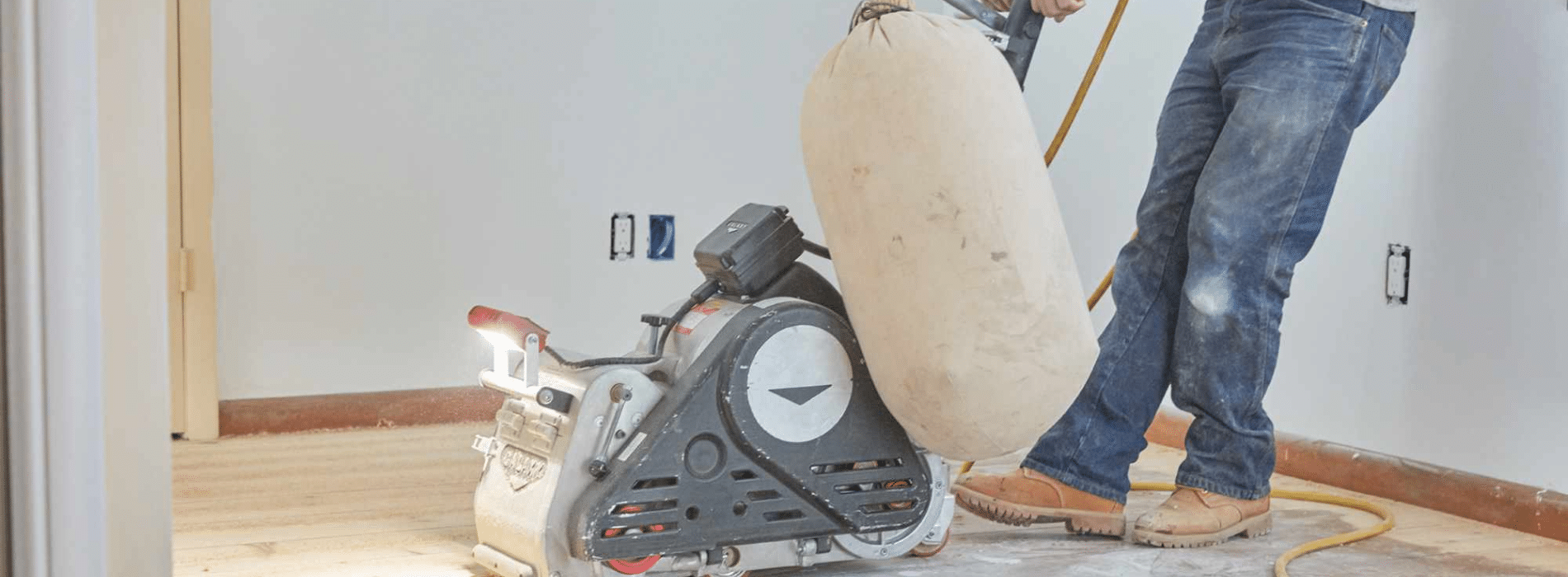 Image of a Bona Scorpion drum sander being operated by Mr Sander® in New Cross, SE14. The sander, measuring 200 mm in dimension, is efficiently sanding a parquet floor. It runs on a power supply of 1.5 kW, operating at a voltage of 240 V with a frequency of 50 Hz.