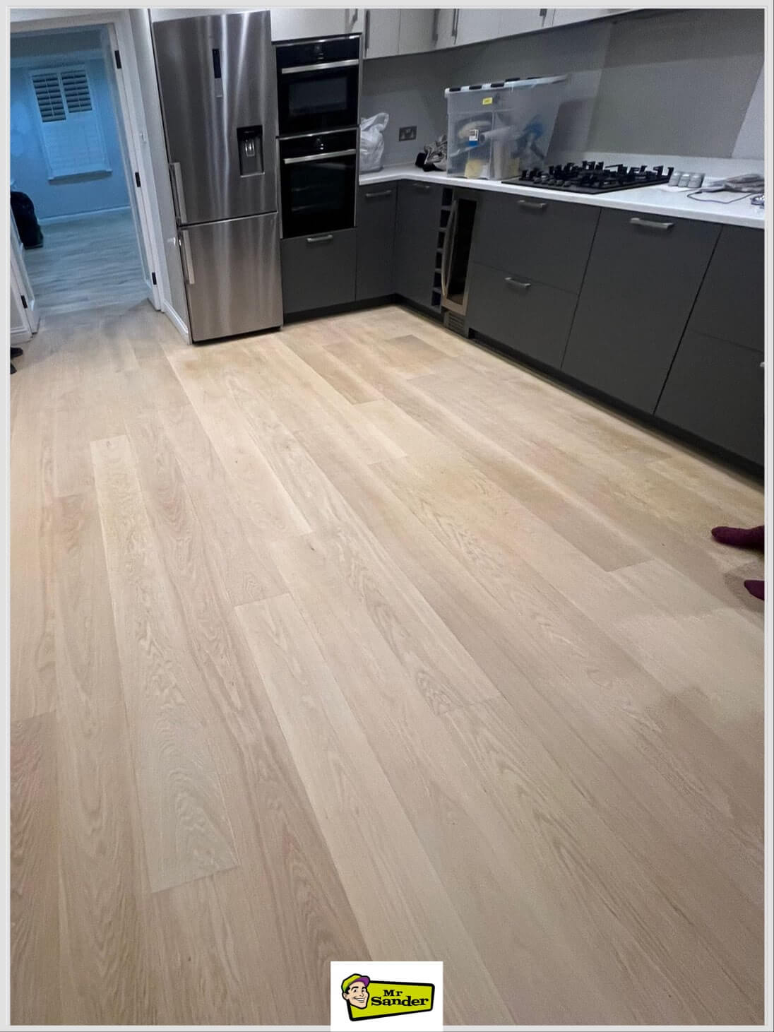 A newly installed wooden floor in Upstreet CT3, showcasing warm tones and a precise fit by Mr Sander®.