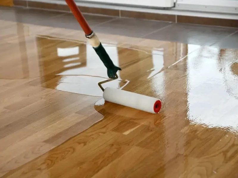 applying polyurethane finish to a stained wood floor