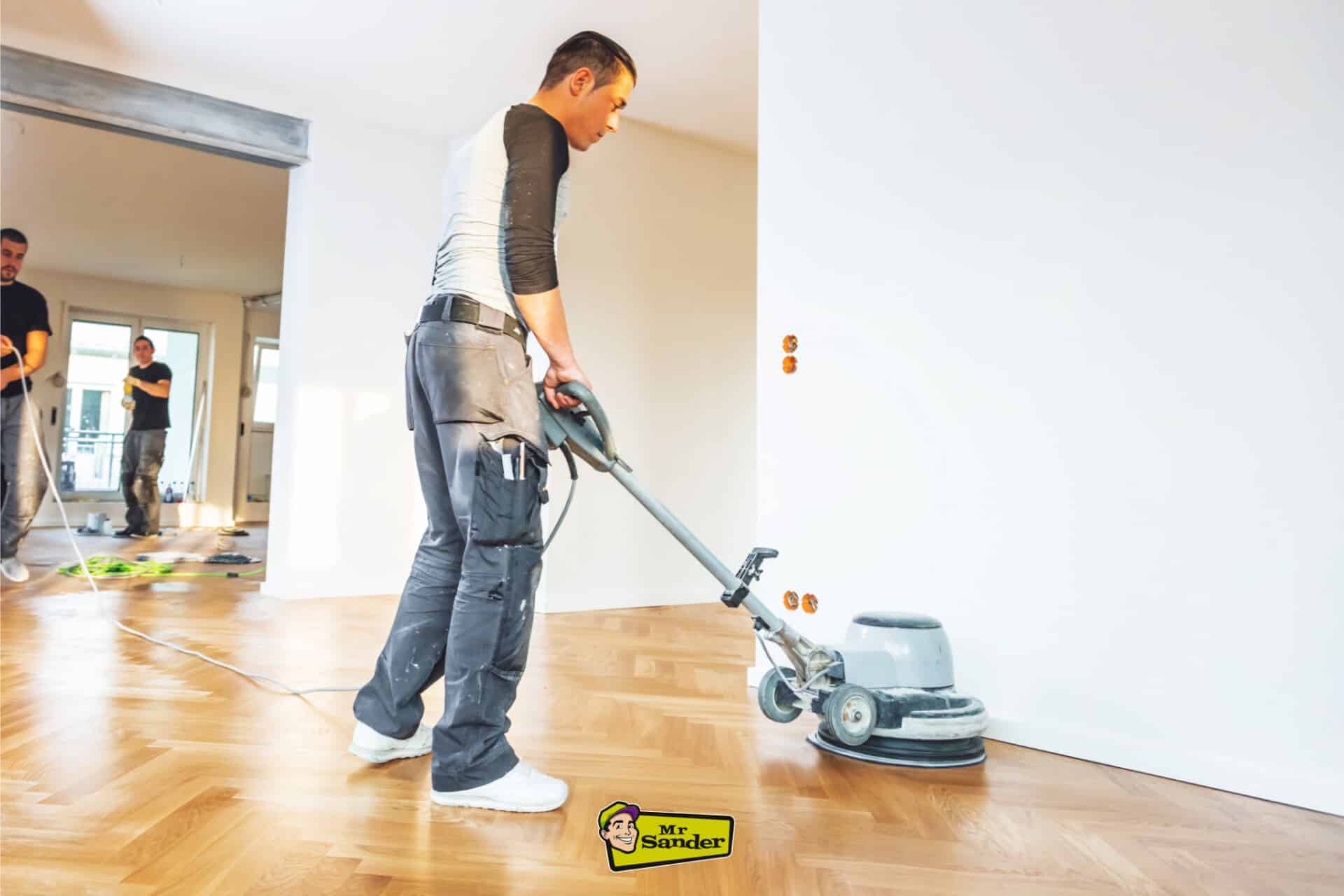 A sanding machine being used on oak parquet flooring during the restoration process, leaving behind a smooth and uniform surface with a medium oak finish. Professionally managed by Mr Sander in Chalkwell.