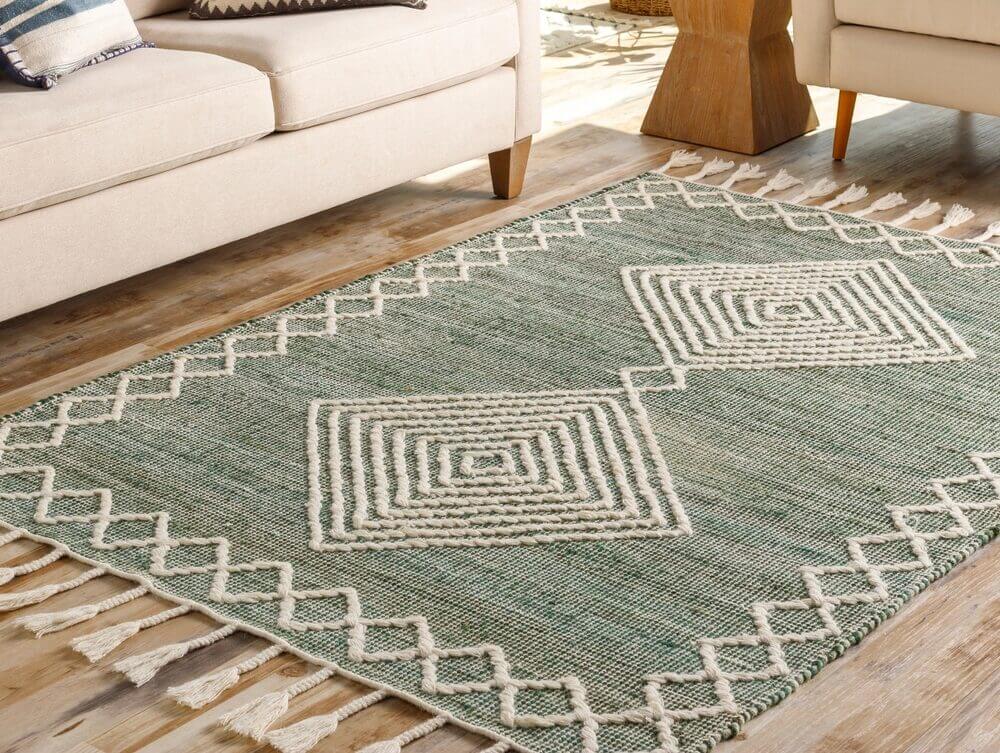 Green decorative rug on a wooden floor, illustrating a stylish way to hide or prevent scratches.