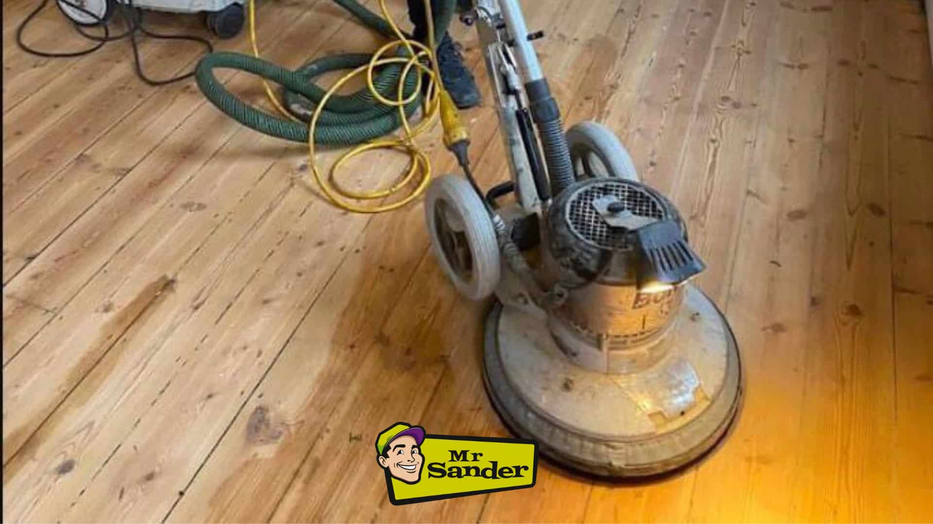 A professional from Mr Sander® sanding a floor in a living room in, UK using the Bona FlexiSand 1.9 (AMO310002) buffer. The machine features a 1.9 kW motor, 230 V voltage, 50 Hz frequency, 407 mm disc diameter, 147 rpm abrasive disc speed, and weighs 50 kg.