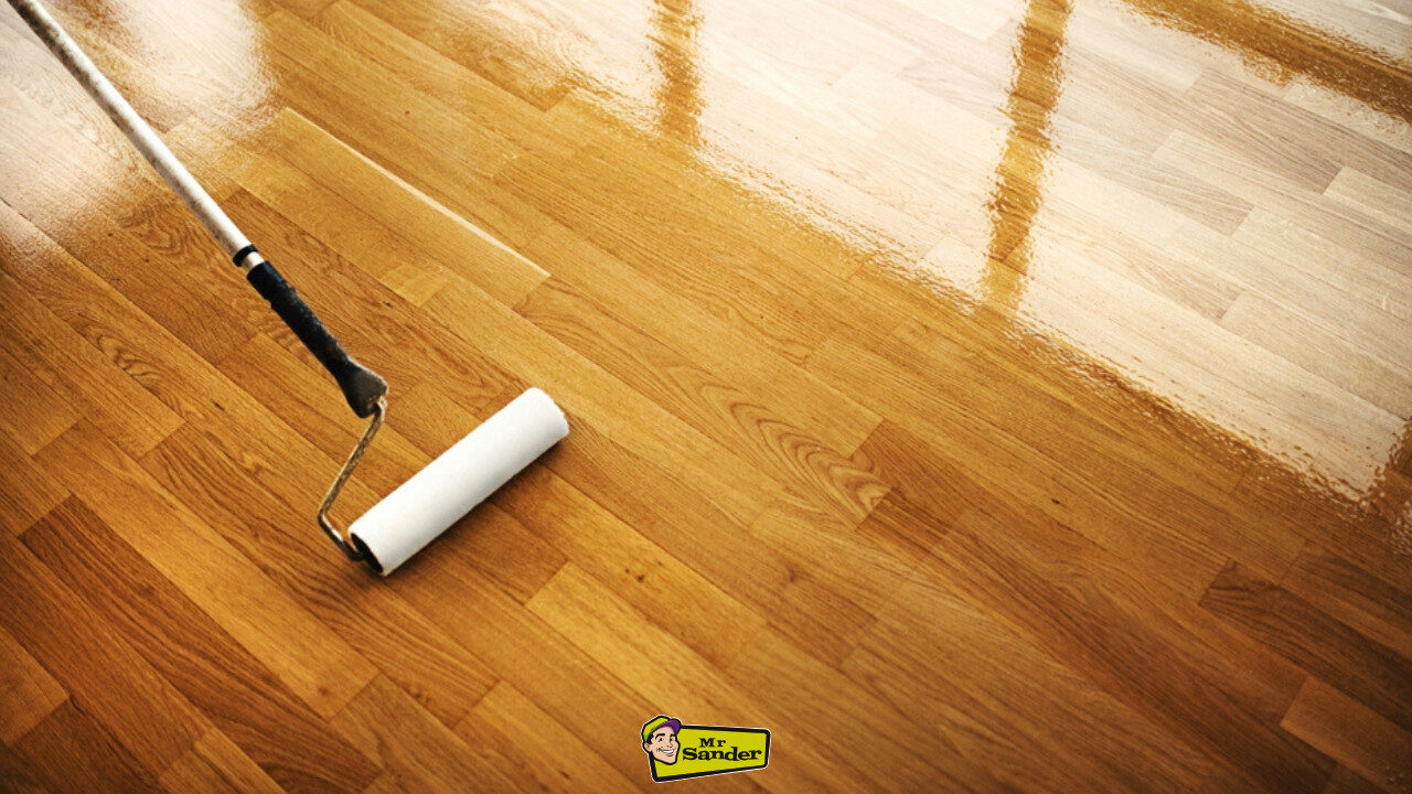 A roller applying a protective finish to a hardwood surface, demonstrating a crucial step in professional Floor Care.