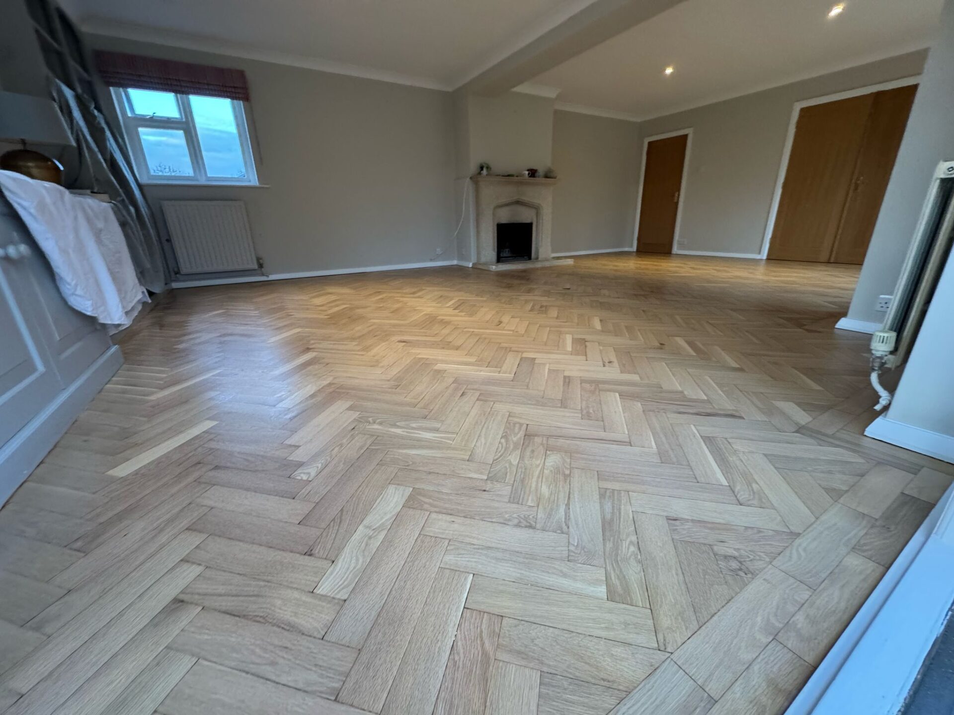 Bright herringbone oak parquet living-room floor after professional Floor Sanding and Light Stains treatment