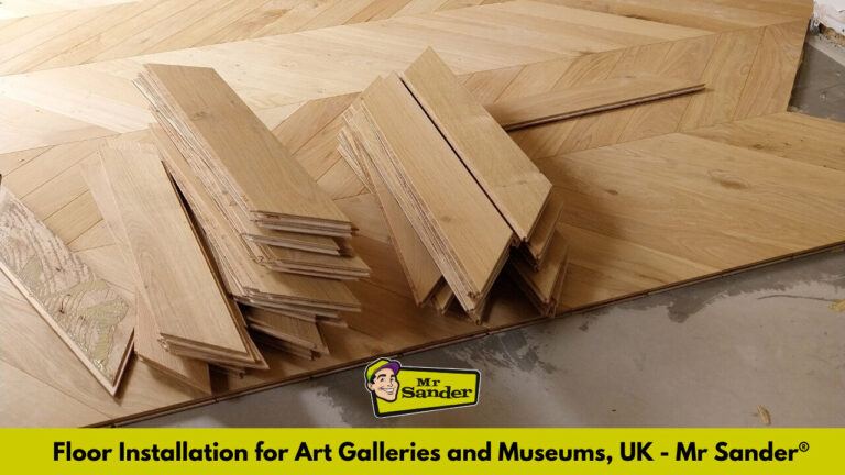 Stacks of oak planks arranged in a chevron pattern, illustrating professional floor installation for art galleries and museums.