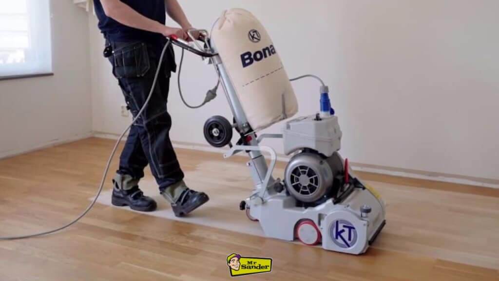 A professional floor refinisher operating a large Bona-brand drum sander on a hardwood floor.