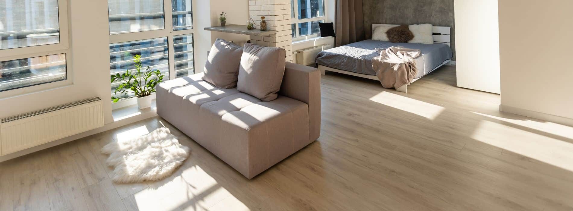 Mr Sander® have masterfully refinished a living room wooden floor, creating a stunning space filled with furniture and natural light from the windows.