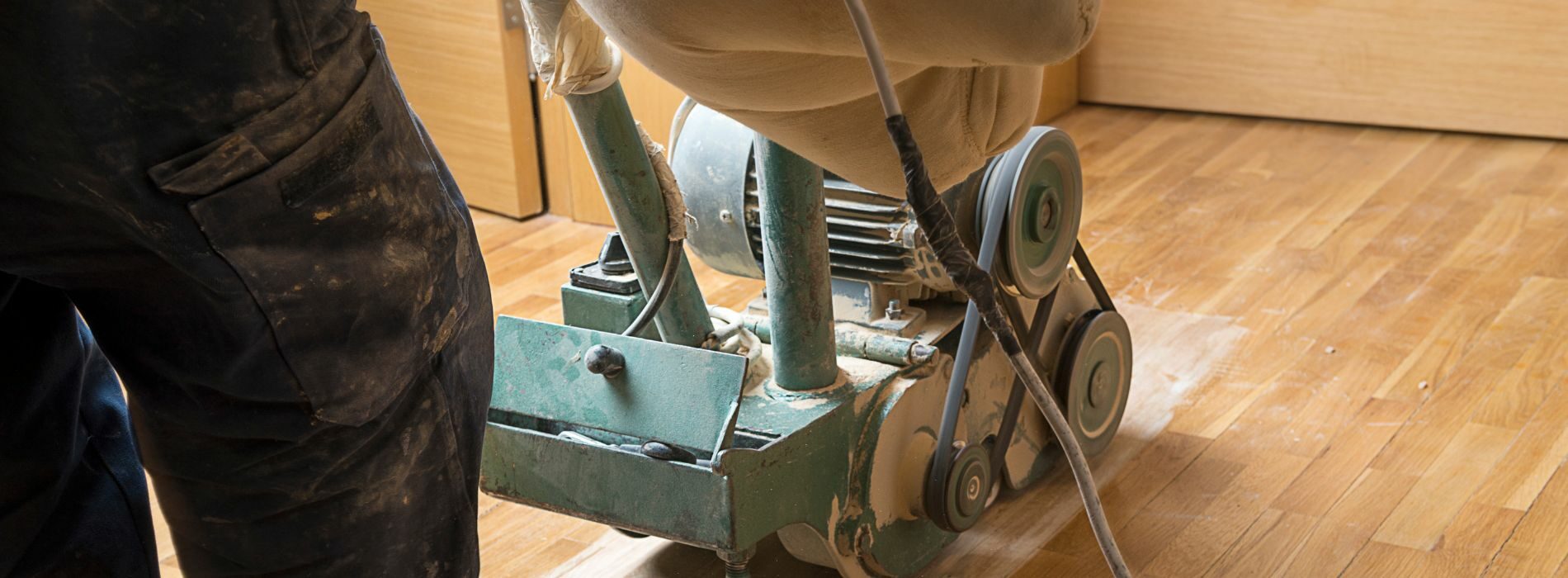 a person working on a machine on a hard wood floor.