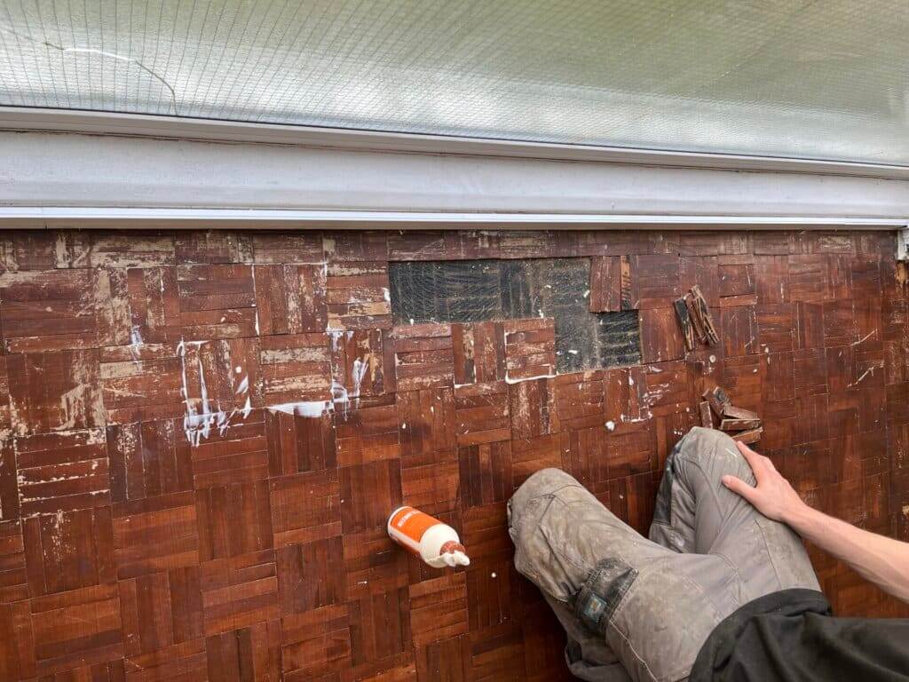 Parquet floor repair in progress in Wiston, showcasing detailed craftsmanship by Mr. Sander's professional restoration team.