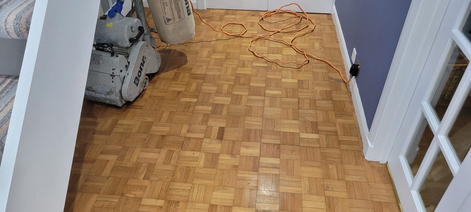 Floor Sanding and Restoration underway on an oak parquet hallway using a Bona dustless drum sander.