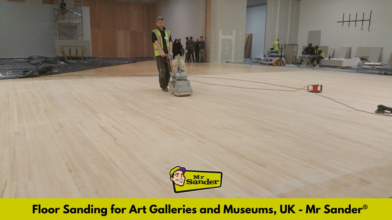 A professional floor sander operating a drum sander on a large museum floor, demonstrating the process of floor sanding for art galleries and museums.
