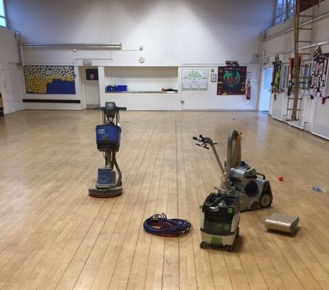 Professional floor sanding equipment in use on wooden floors, ideal for basement floor restoration and maintenance in moisture-prone areas.