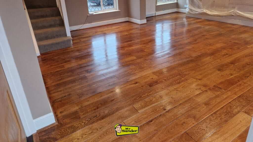 Beautifully restored wooden floor in a spacious East Twickenham home, showcasing the polished and vibrant surface achieved through expert sanding and refinishing by Mr. Sander.