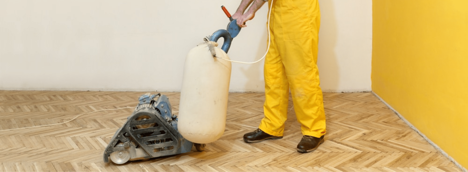 In Hainault, IG7, Skilled Mr Sander® using a powerful Bona drum sander (Dimension: 200 mm, Effect: 2,2 kW, Voltage: 240v) connected to a HEPA-filtered dust extraction system, expertly sand a herringbone floor.