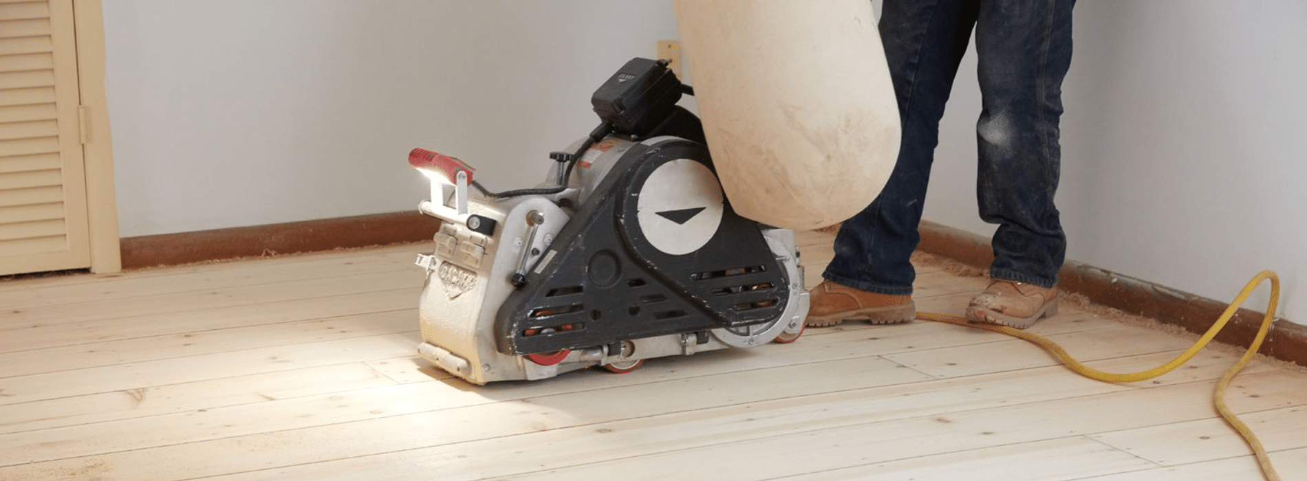 Mr Sander® using a Bona Scorpion, a 200mm drum sander, are sanding a parquet floor in Upper Holloway, N19. With 1.5kW power, 240V voltage, and 50Hz frequency, they ensure clean and efficient results. The sander is connected to a dust extraction system equipped with a HEPA filter.