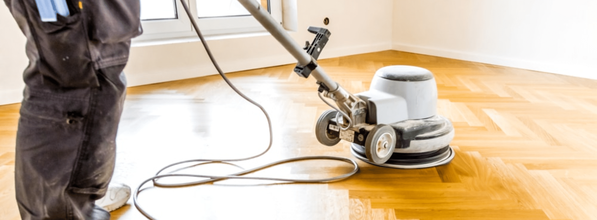 Mr Sander® at work, using the powerful Bona buffer sander with the specifications - Effect: 2200, Voltage: 230, Frequency: 50, and Size: 200x750 mm. They are seen restoring herringbone floors to perfection in Golders Green, NW11, using a highly efficient dust extraction system with a HEPA filter, providing flawless results in a dust-free environment.