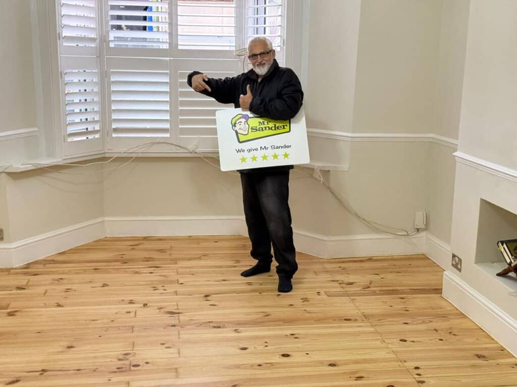 a man holding a sign in a room