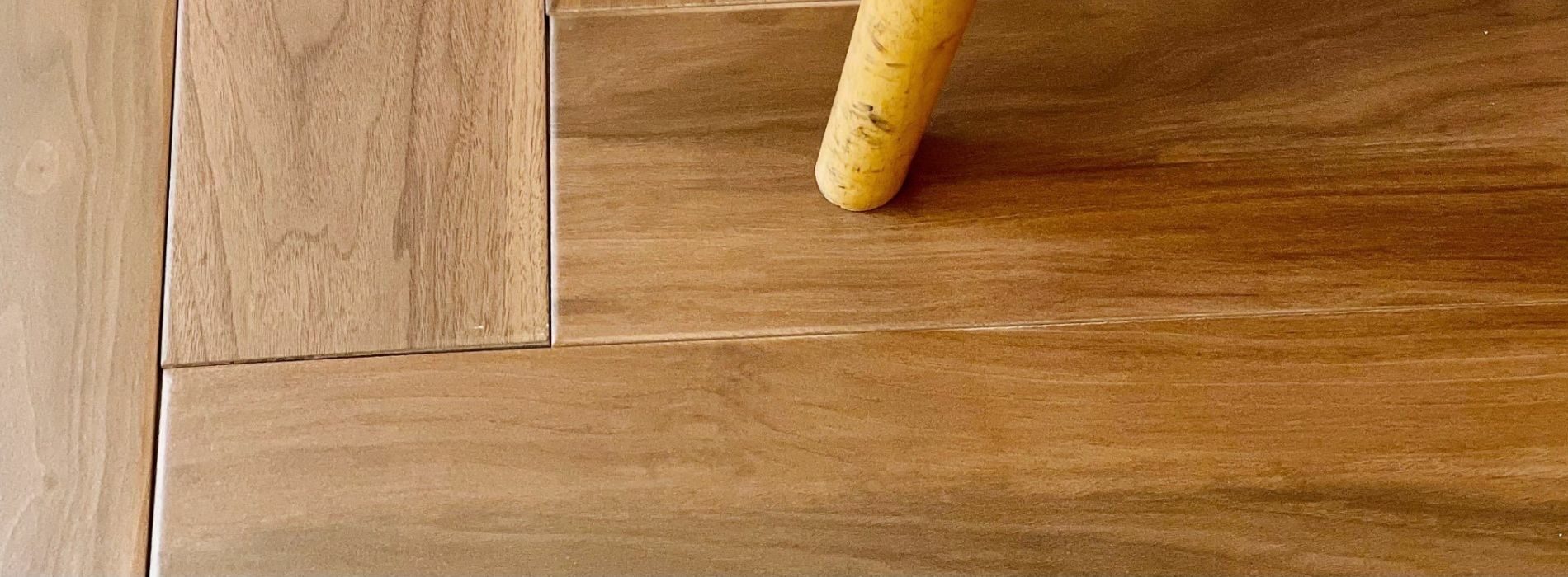 A close up of a wooden floor with a bat on it. 