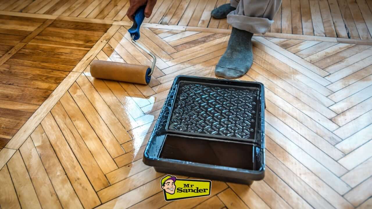 Applying varnish to a herringbone parquet floor during a restoration project by Mr. Sander in Henfield.
