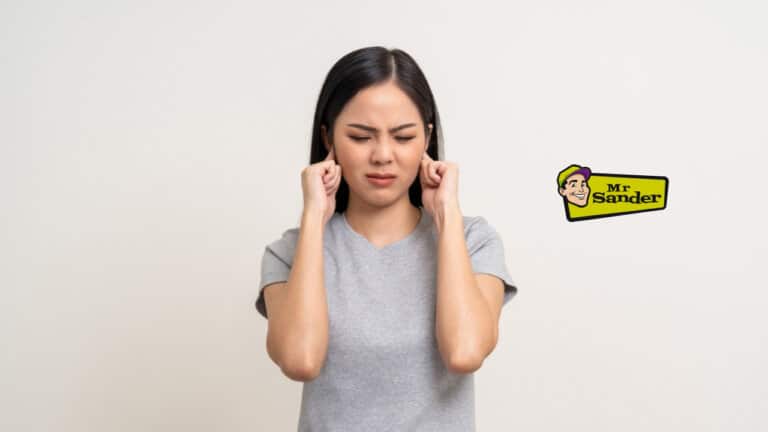 A woman with a distressed expression covers her ears with her fingers, standing against a plain background. The "Mr Sander®" logo is visible in the top right corner.