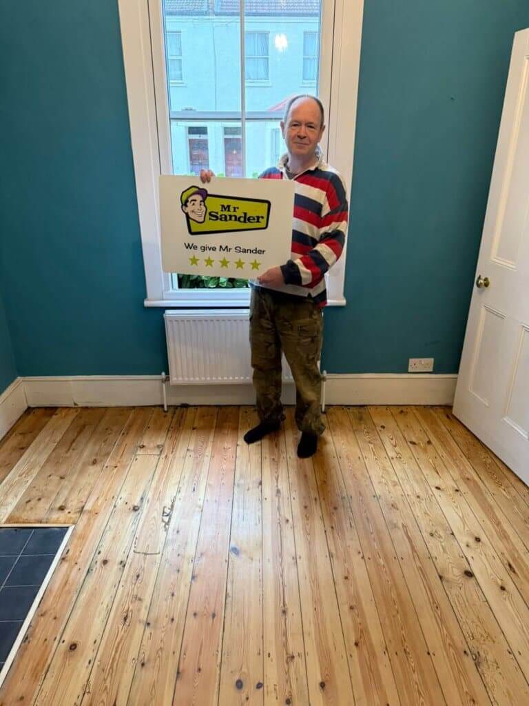 Mr. Sander® technician performing dustless floor sanding on a wooden floor using a Bona Belt 250x750 belt sanding machine, paired with a professional Bona vacuum cleaner for optimal dust extraction.