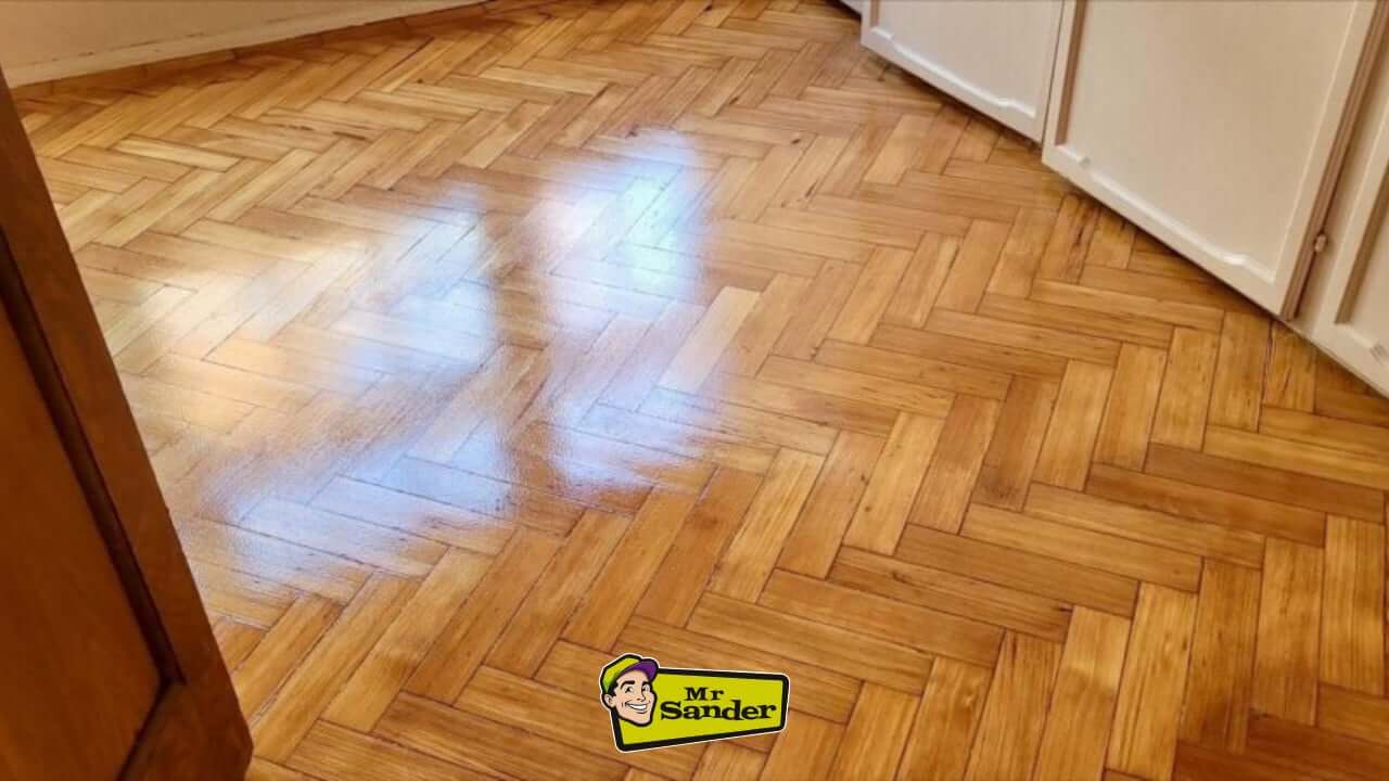 Herringbone parquet floor fully restored and polished to a flawless glossy finish by Mr Sander in Manchester.