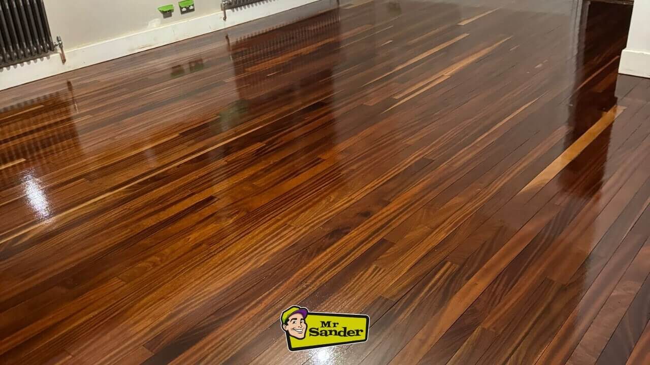 High-gloss walnut boards with a rich mahogany hue installed through expert Junckers Floor Fitting, reflecting flawless craftsmanship.