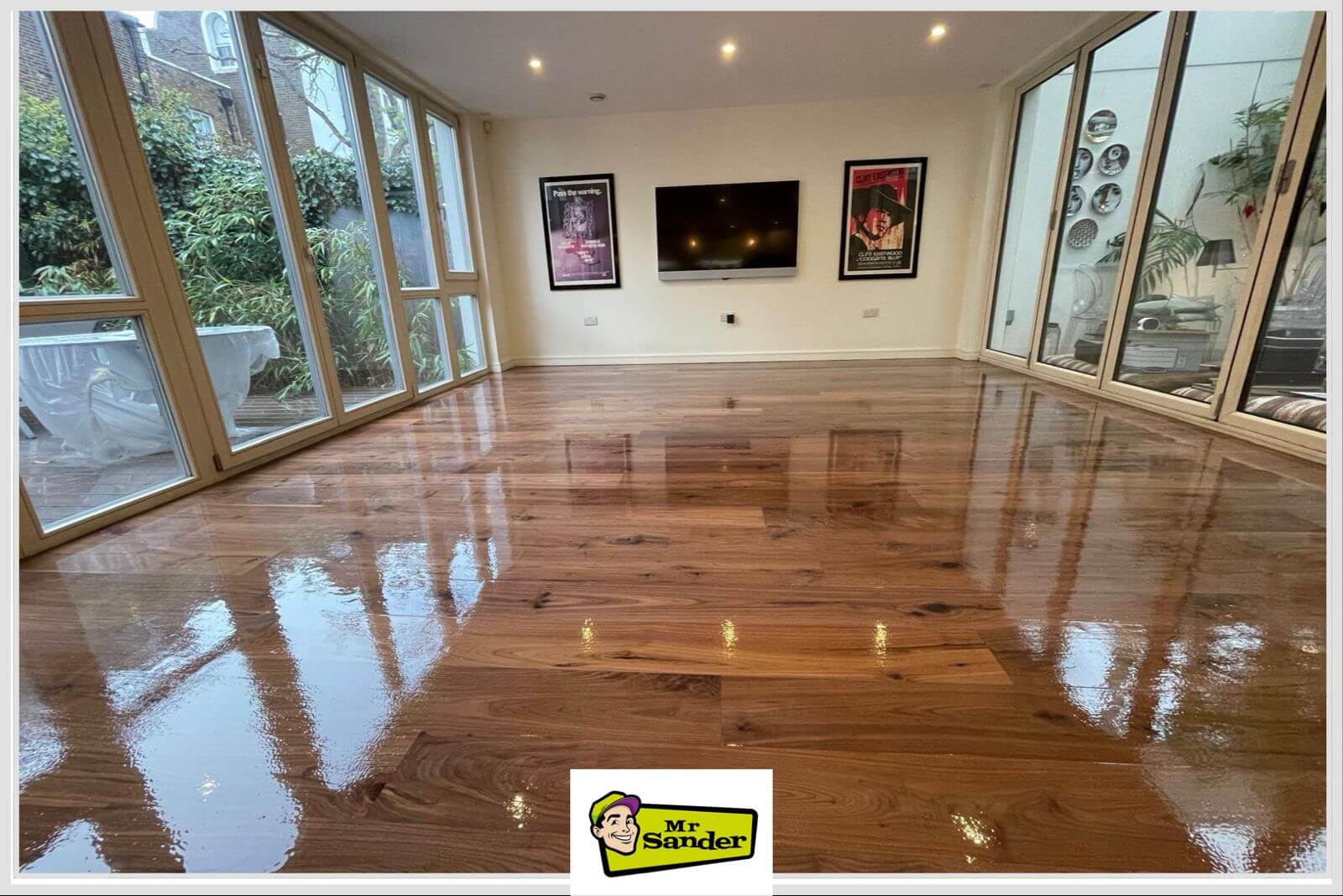 High-gloss Natural Hardwood Floors reflecting the room’s floor-to-ceiling windows and modern decor.