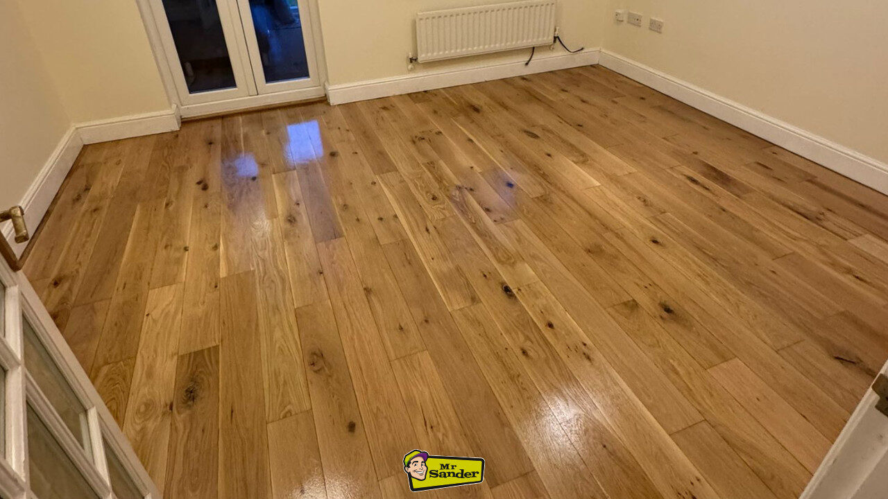 Refinished wooden floor in a tidy living space, highlighting the importance of Preparing Your Floor for Sanding for a flawless, polished finish.