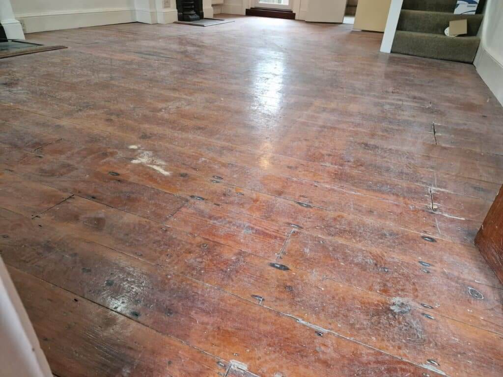 Example of a floor that needs full sanding due to peeling and deep damage.