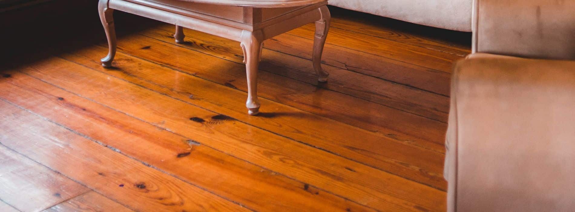 A wooden table sitting on top of a hard wood floor. 