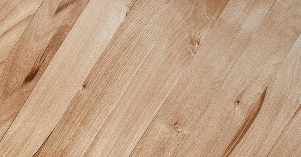 Close-up of light brown wooden floor planks with natural grain patterns.