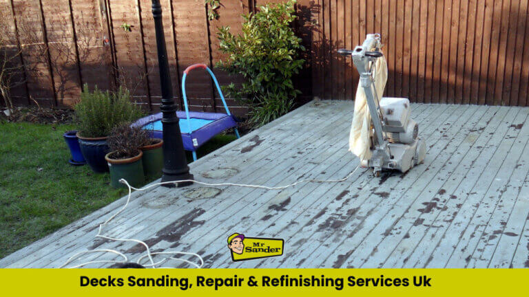 A partially sanded outdoor deck in a UK garden, with a professional floor sanding machine ready to restore the worn-out wooden surface.