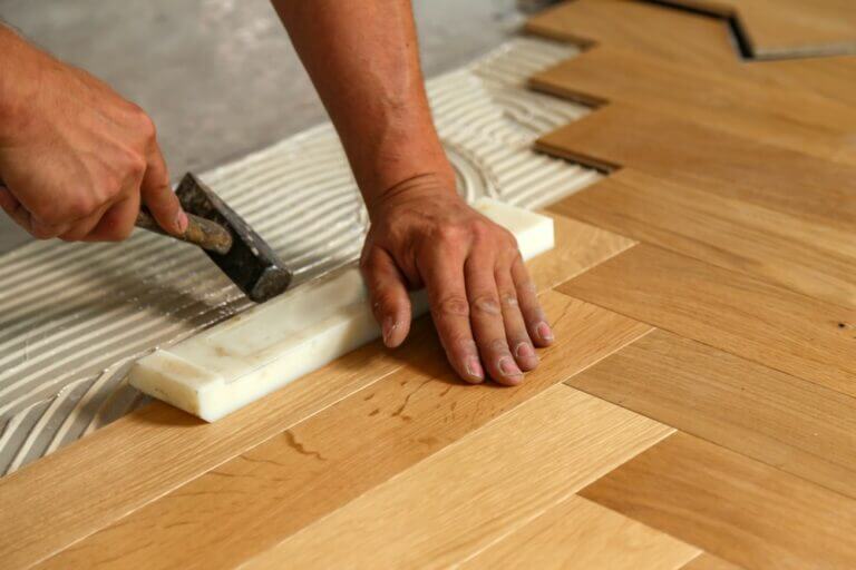 Worker,Laying,Parquet,Flooring.,Worker,Installing,Wooden,Laminate,Flooring