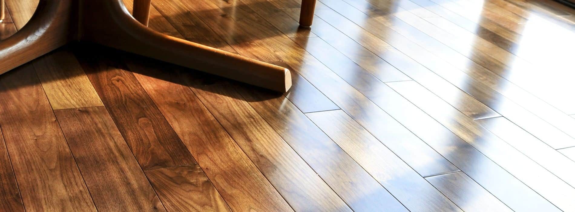 A close-up of a wooden floor with a chair. 