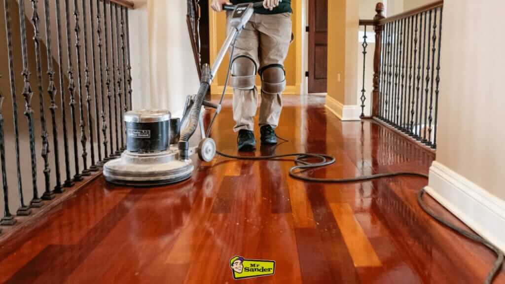 A Mr Sander®️ professional buffing a wood floor in Doune (FK16) to quickly restore its natural sheen.