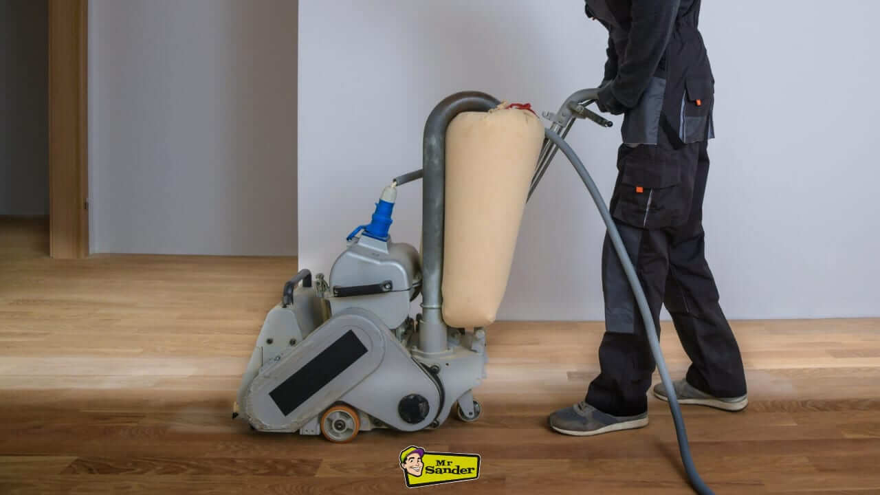 A professional Mr. Sander technician using a floor sanding machine to refinish a hardwood floor in Syon Park (TW8), showcasing expert restoration techniques.