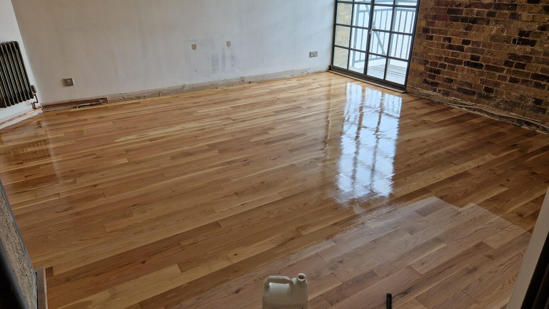 A newly sanded and freshly sealed hardwood floor, showcasing the reflective shine that results from The Art of Floor Sanding.