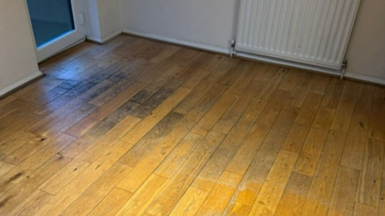 A narrow kitchen floor before refinishing, showing faded boards ready for a professional makeover to transform tired floors through expert sanding and lacquering.
