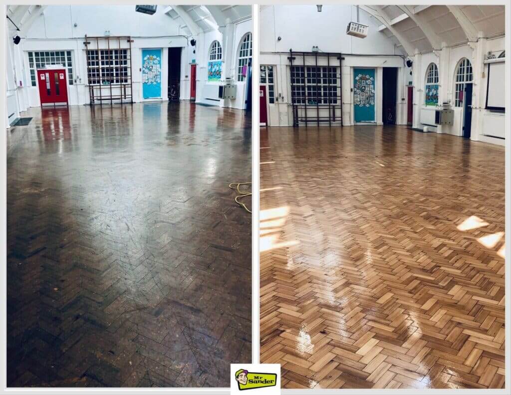 A before and after comparison of a large hall with a herringbone wood floor. The left side shows the floor in its worn state, with a dull, dark finish and visible scratches. The right side displays the same floor after being sanded and refinished, now bright, polished, and gleaming. The space features high arched ceilings, red doors, and windows, creating a spacious and inviting atmosphere.