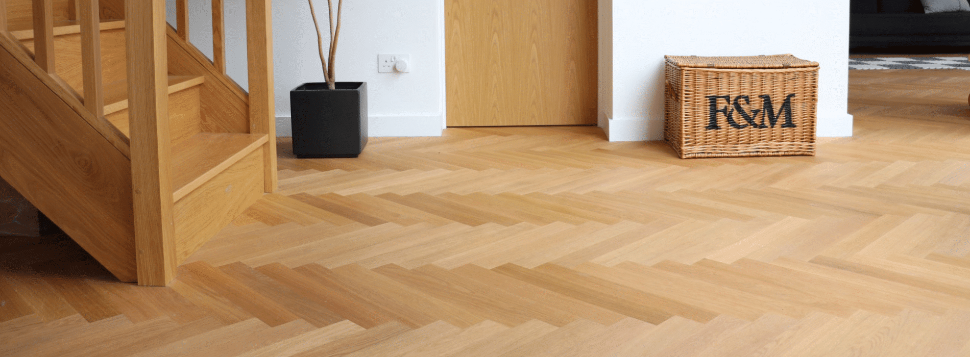 Restored engineered oak floor in Tower Hamlets, E1 by Mr Sander®. Enhanced with mid-oak stain, Junckers Strong satin finish, showcasing rich grain patterns and tones.