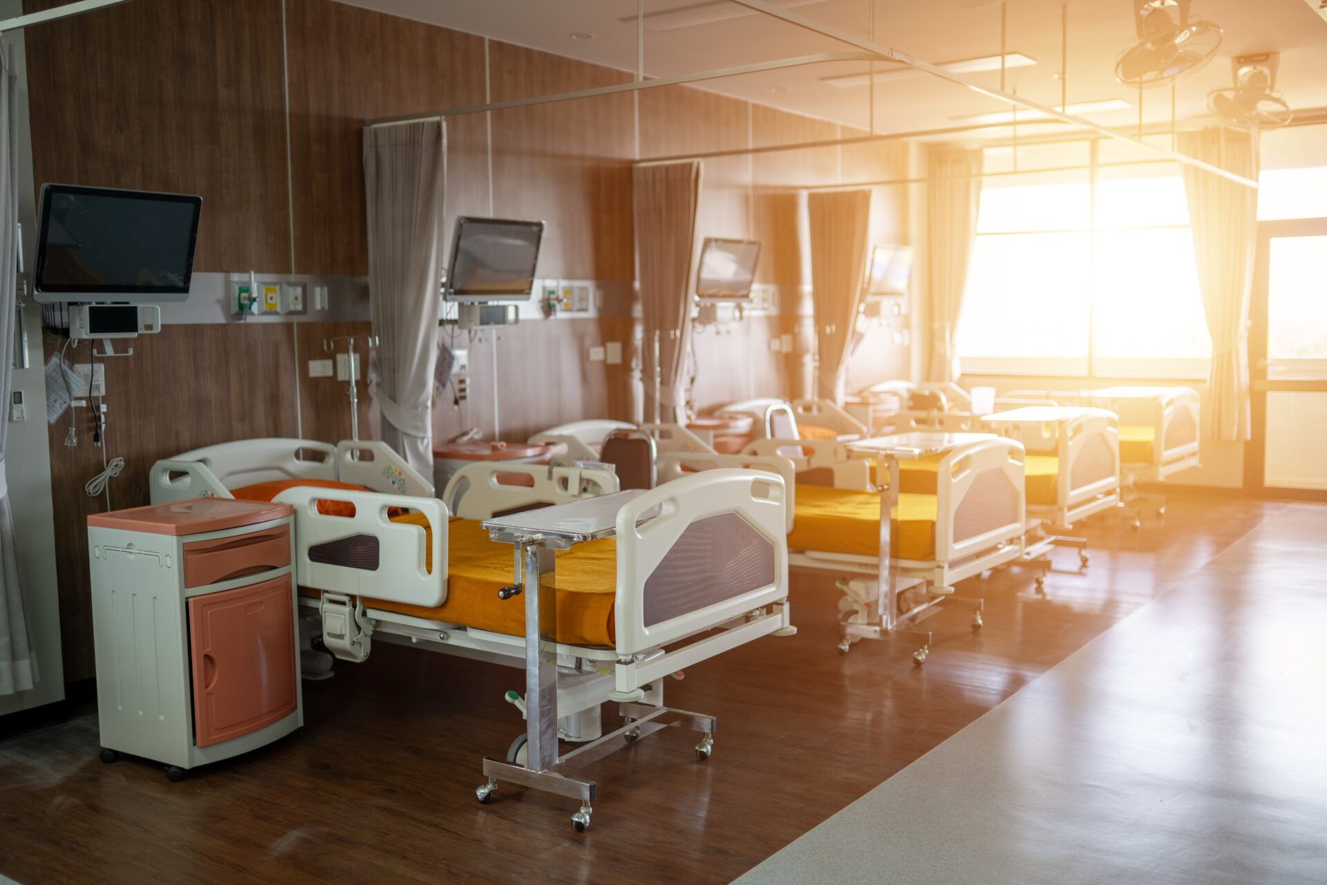 Multi-bed hospital ward with zoned wood-effect vinyl plank flooring and slip-resistant safety vinyl walkway after expert Floor Installation for Healthcare Facilities