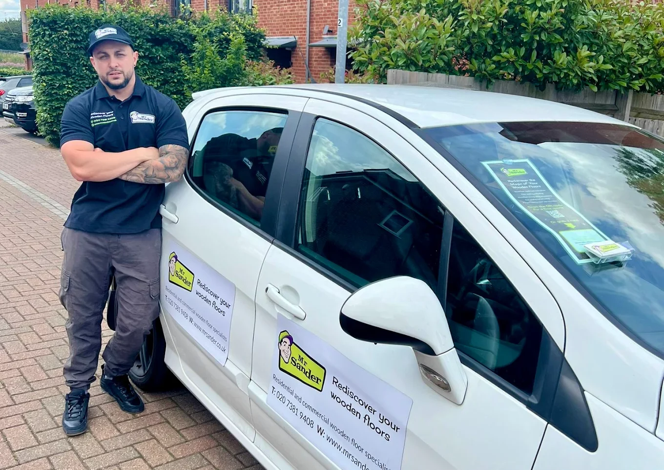 Mr Sander technician standing beside a branded service vehicle, ready for wood floor restoration—Before and After Floor Transformations.