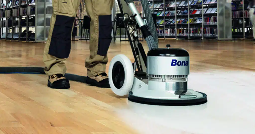 Commercial floor polishing with a Bona brand buffer machine in a public space.