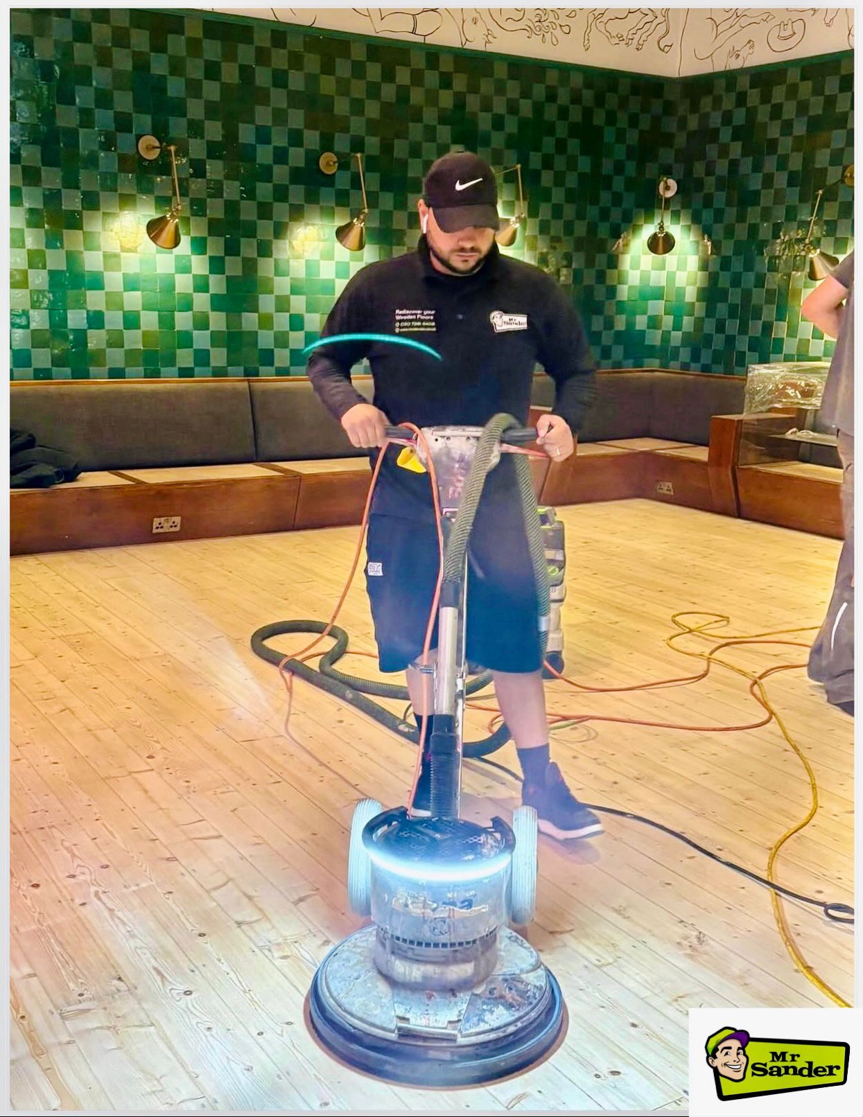 Mr Sander® technician using a dust-free rotary buffer to sand a commercial wood floor in Havering RM12.
